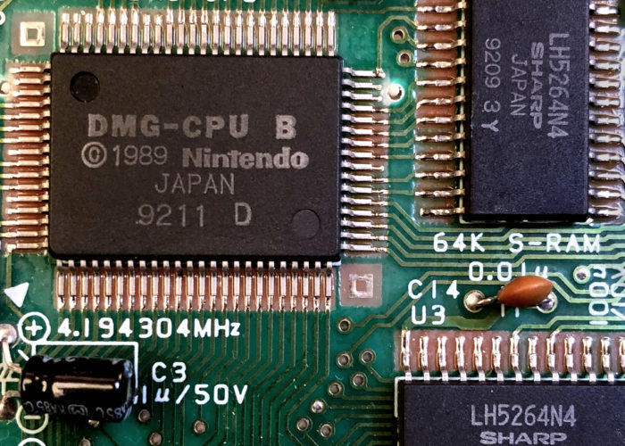 A closeup of a circuit board with several visible chips.