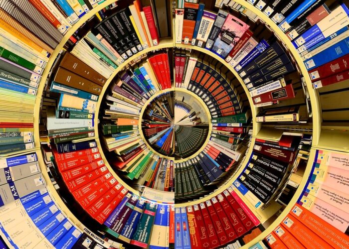 A spiral of books on library shelves appears almost as though a pie chart.