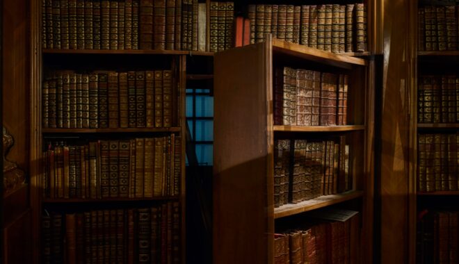 A bookcase opens to reveal a secret passageway.