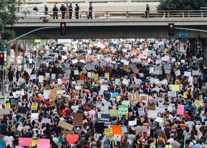A large protest passes under an underpass in Los Angeles.