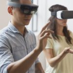 Two people with VR headsets on.