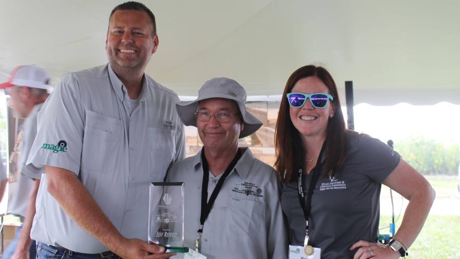Jeff Reffett from Nutrien, center, accepts the Applicator of the Year Award from IFCA President Kevin “K.J.” Johnson, left, and IFCA Chair Meg Steward of Yargus Construction. 