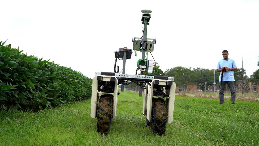 Samuel Singh, a doctoral student in the agricultural sciences program, showcases a robot equipped with multiple cameras that can capture plant diseases on soybean crops. Under the guidance of Billy Ram, assistant professor of precision agriculture, the goal is to collect enough data to predict the diseases before symptoms appear on the leaves and stems. Photo credit: Todd Duermyer