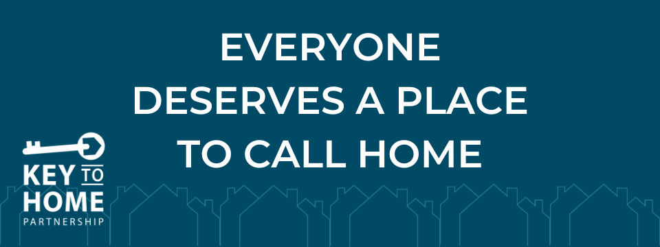 Dark blue background with line art of houses outlined in a lighter blue. There is white text above the outlined houses that reads 