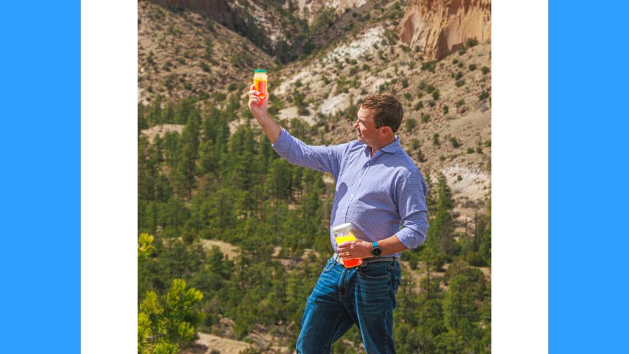 UbiQD founder and CEO Hunter McDaniel marvels at jars of glowing quantum dots at the company’s headquarters in Los Alamos, NM.