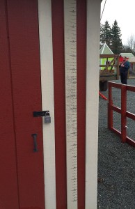 Kids pencil in their height at the Pony Ride shed.