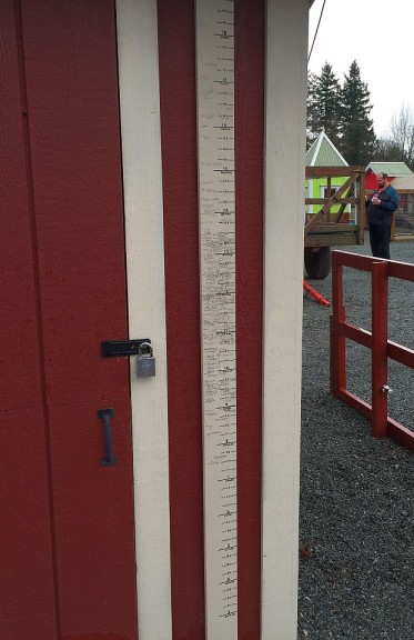 Kids pencil in their height at the Pony Ride shed.