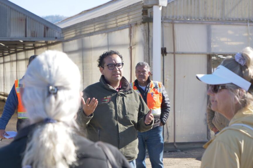 Francisco Castaneda welcomes the Biocontrol USA tourists to Growers Transplanting.