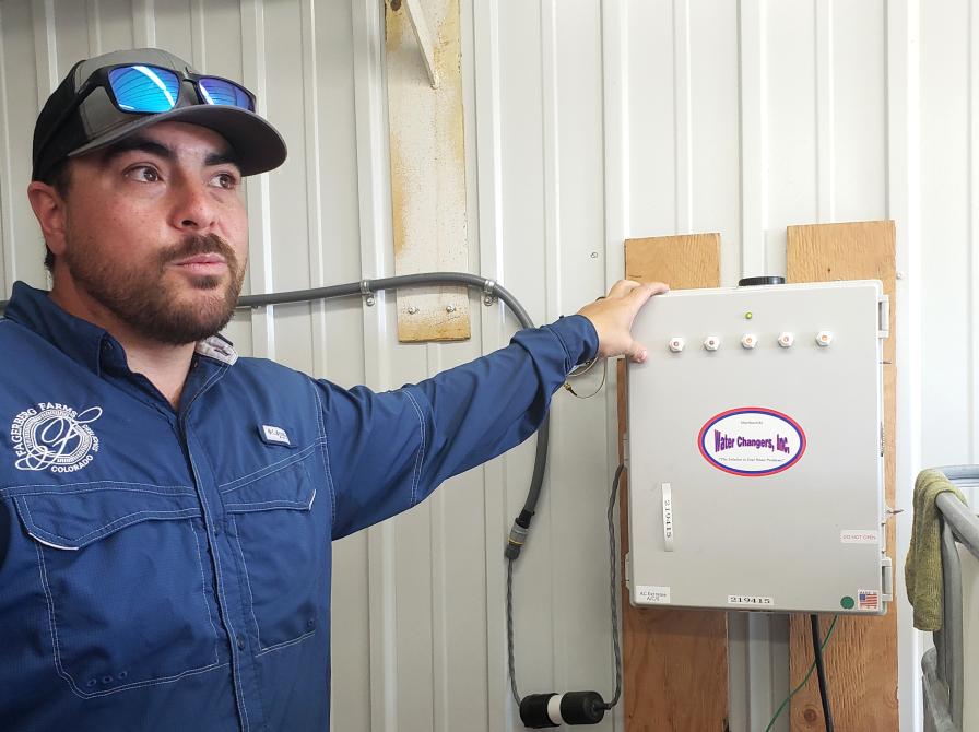 Brian King of Fagerberg Produce showing off irrigation control system