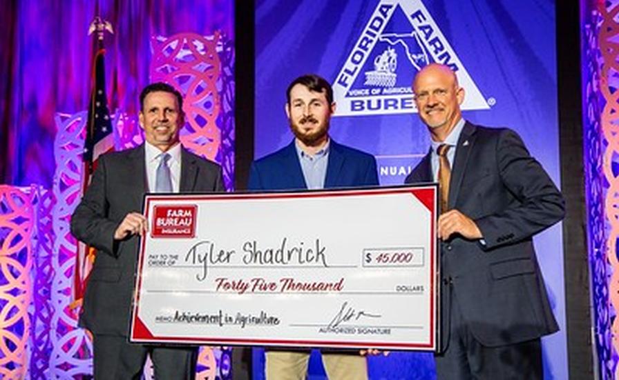 2025 Florida Farm Bureau award winner Tyler Shadrick with Jeb Smith and Frank Blossom