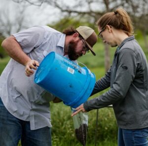 (Staff Photos by Rob Mattson/Noble Research Institute) Nikki Charlton, Ph.D., Lauren Jones, Ph.D., Stephen Swaffar, Shaun Norton, Lane Scogin and Laura Putman work to gather soil samples from the south Texas orchard of cooperator Michael Willard, DVM as part of ongoing research, Wednesday morning, March 22, 2023, near Seguin, Texas.