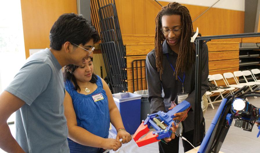Members from Team Bagception demo a 3-D printed robotic claw prototype.