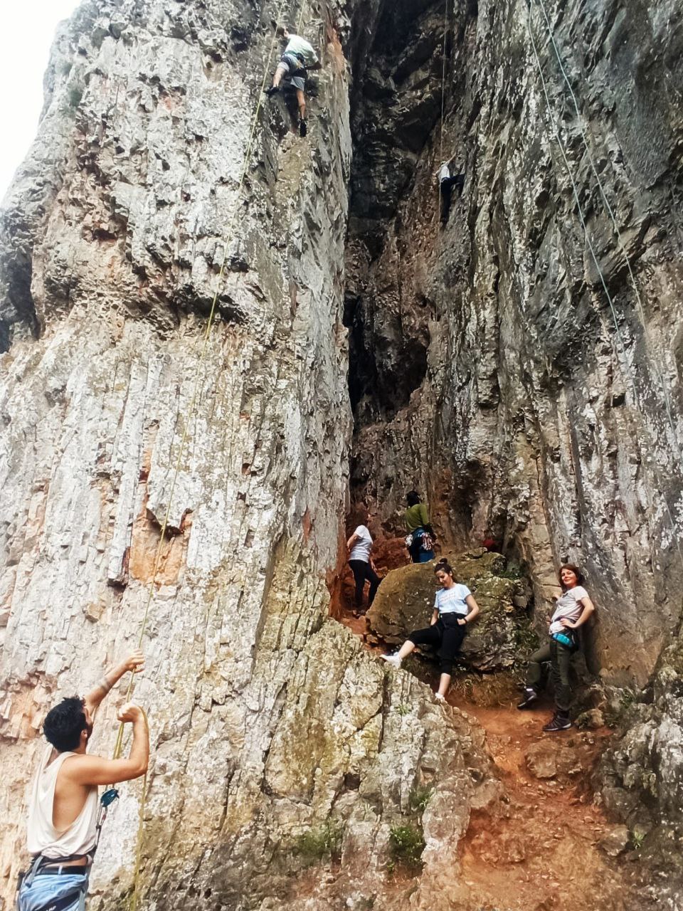 Climbing in the rain under a natural cave at Ballikayalar