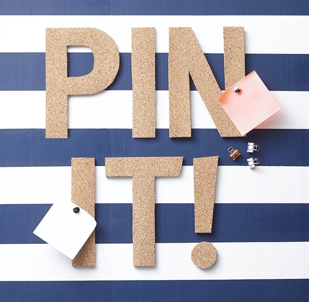 Cork letters spell out 'Pin it!'