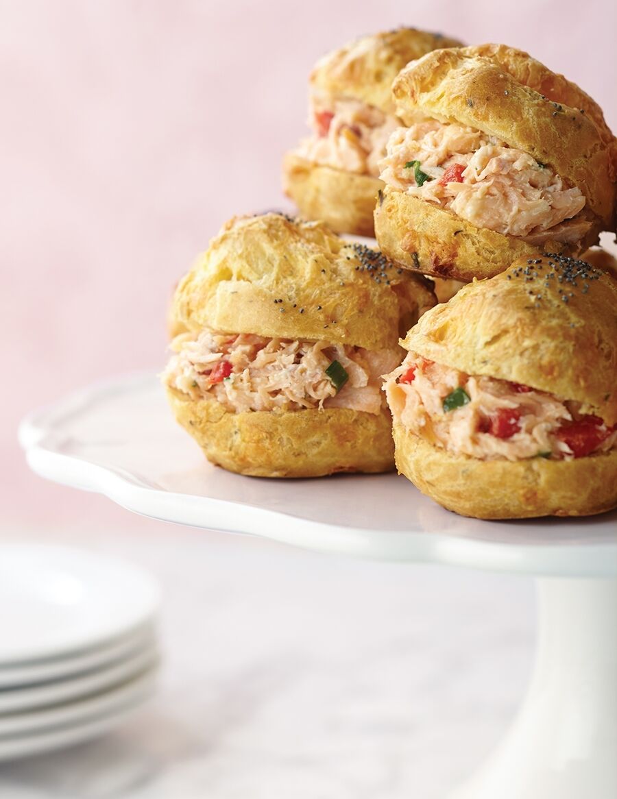 Smoked salmon salad is served on cream puff pastry buns with cheddar cheese and poppy seeds