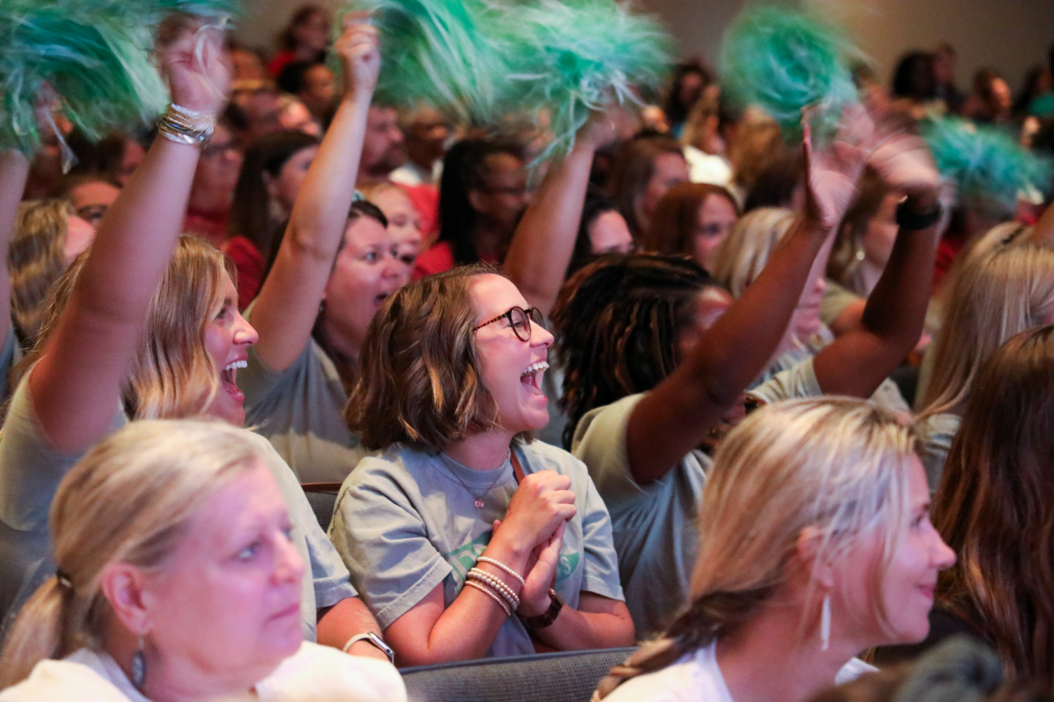 three people sitting in front of table laughing together
