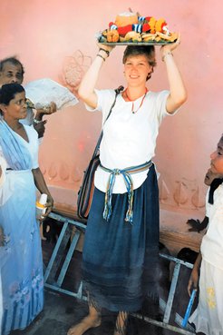 RPCV Lizette carrying a offering on her head