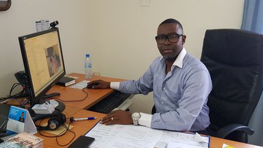 Person sitting in front of computer in office