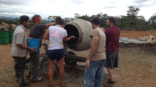 Mixing concrete to build a court