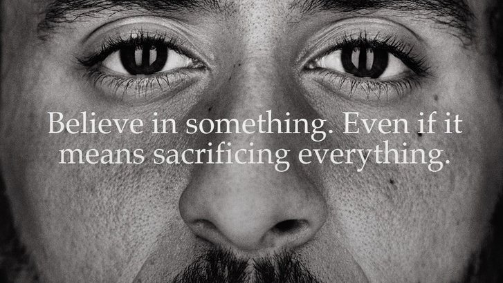 A black and white Nike ad campaign of Colin Kaepernick that says Believe in something. Even if it means sacrificing..."