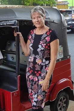Country Director Peace Corps Sri Lanka standing beside a tuk-tuk (three wheeler)