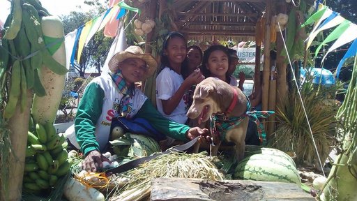 Four people surrounded by fruits and vegetables