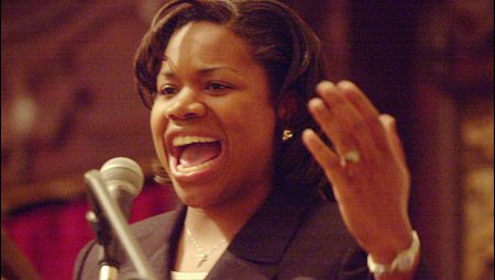 A close up picture of a young, Black woman speaking.