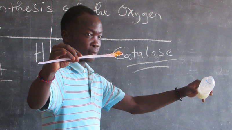Individual in front of black board