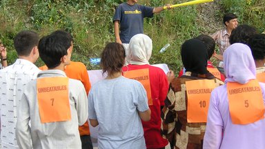 Group of students looking at individual