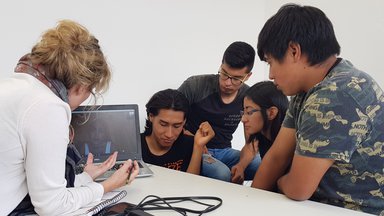 PCRV looking at computer with university students