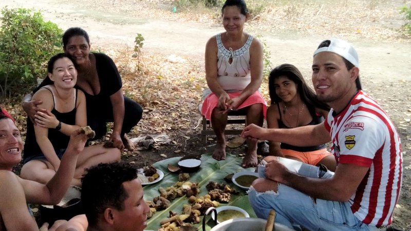 A group of people eat a picnic outside