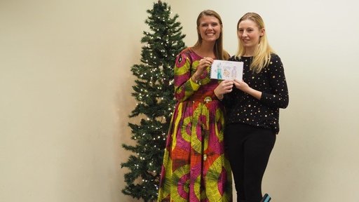 Peace Corps Volunteer Rachel Wallace with an Edison student and one of the books created for students in Senegal.