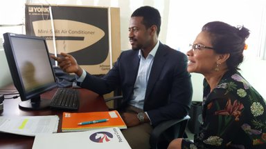 Two people looking at computer screen