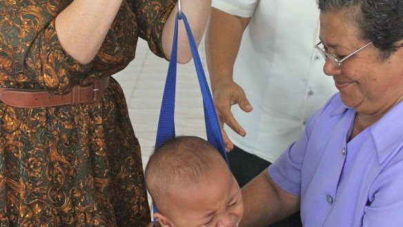 Weighing the babies. This little one wasn't a fan.