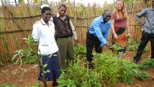 Health center workers show other community members their permagarden.