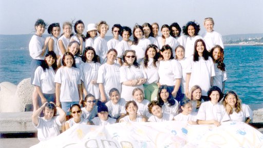 A group of young women pose in a picture. They are the Bulgaria's first GLOW campers in 2000.