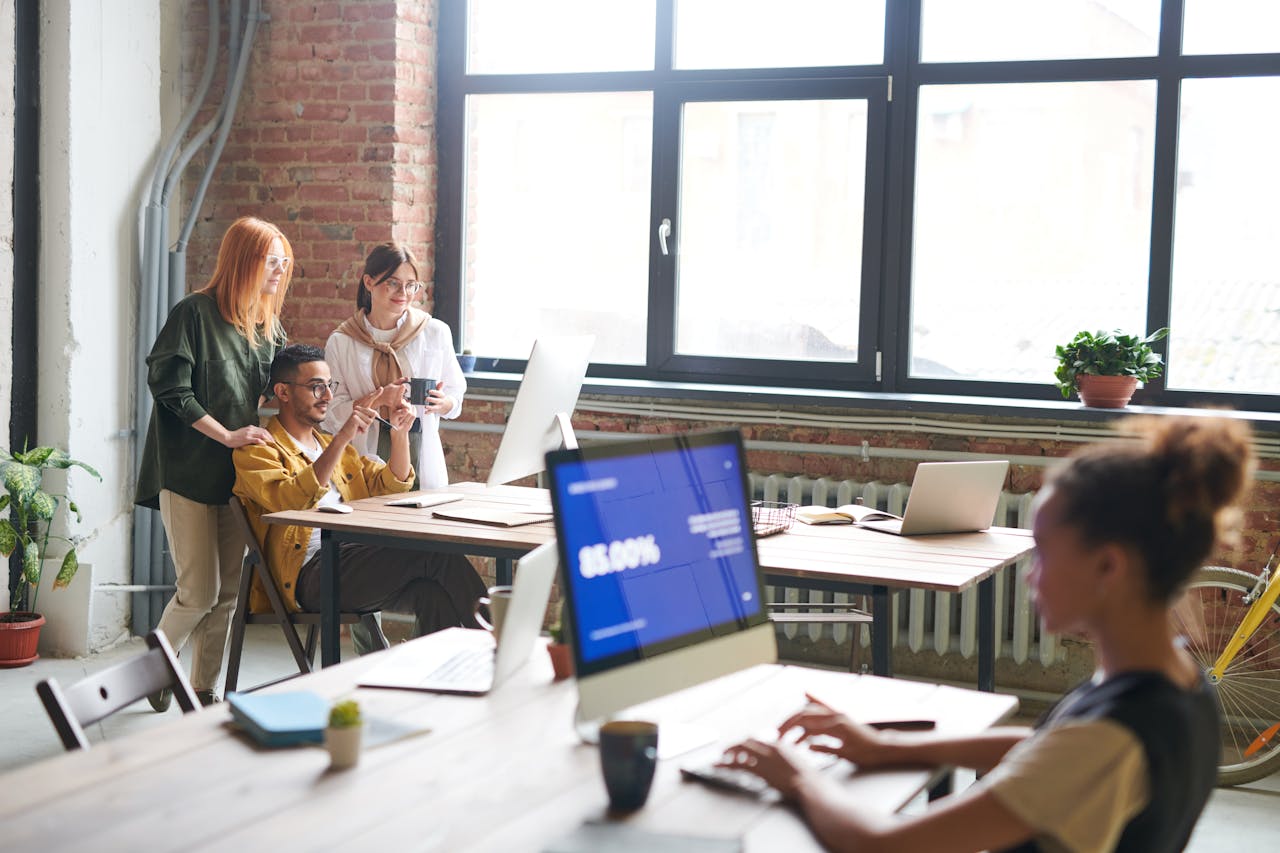 Group of people in an office looking at information on screens