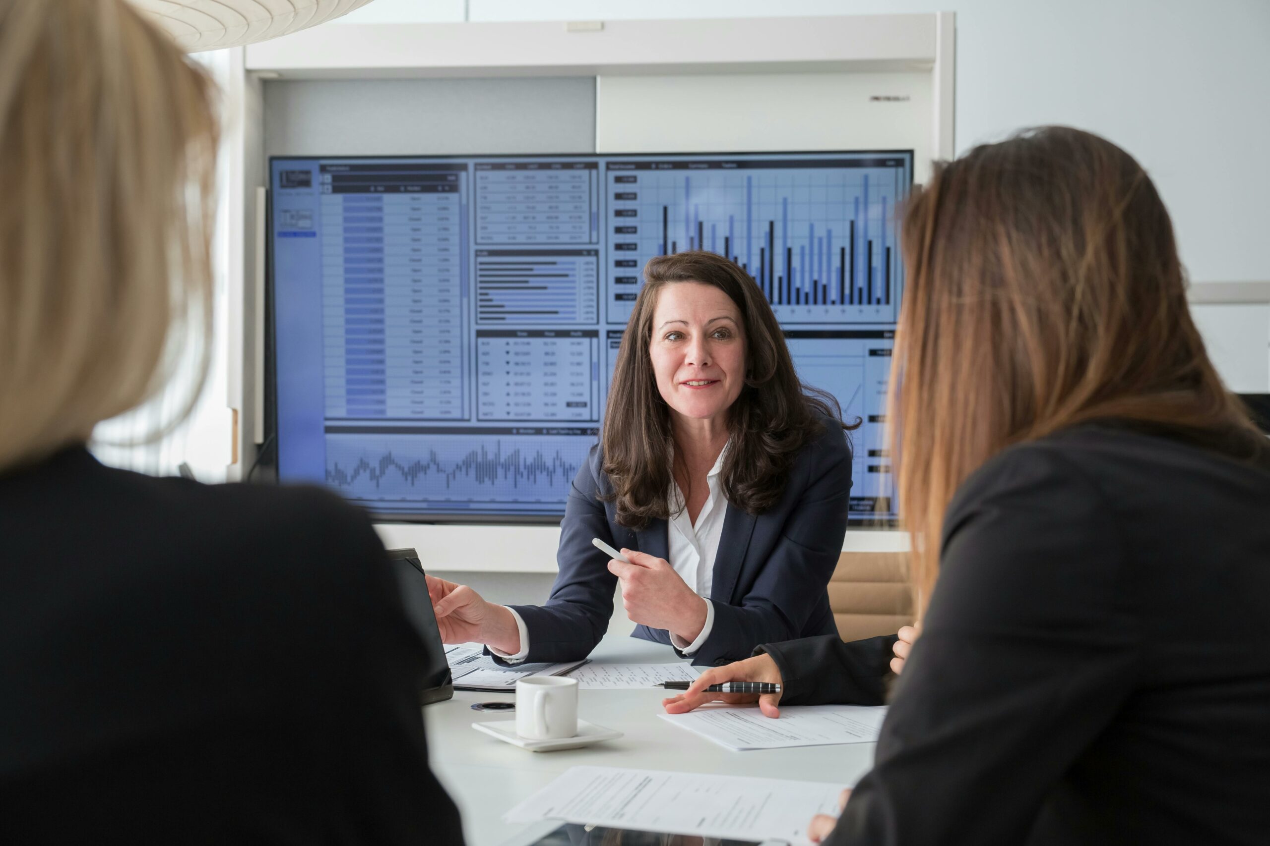 Association leaders reviewing data dashboards together in a meeting, symbolizing how cloud-based platforms connect systems and improve decision-making.