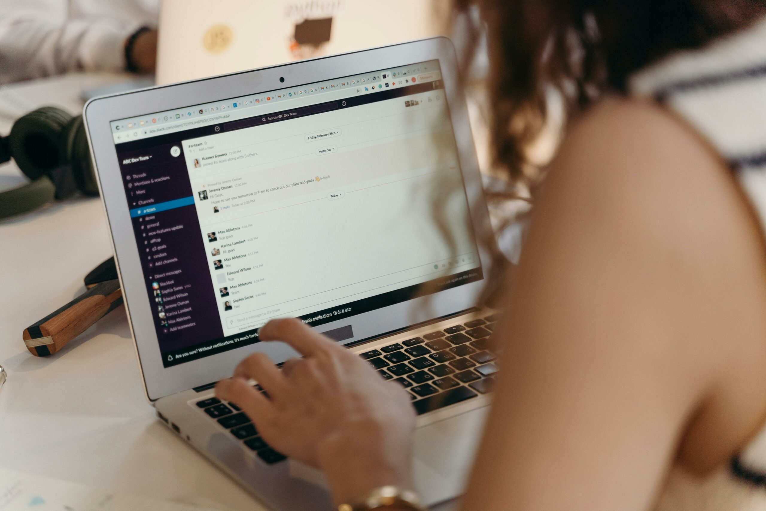 erson working on a laptop, checking messages and planning association email marketing campaigns
