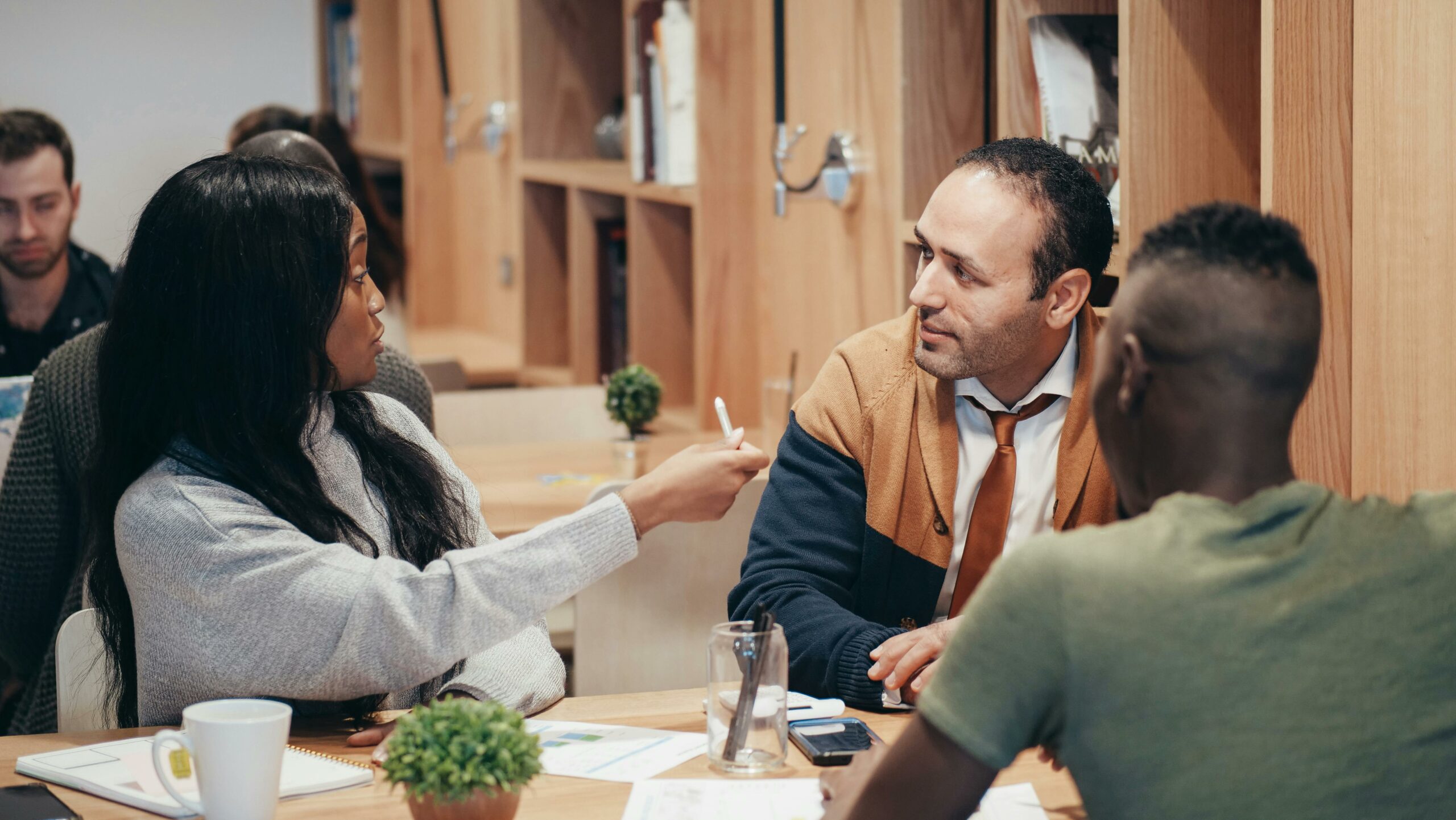 Diverse group of professionals collaborating in a bright modern office, symbolizing strategic planning and partnership opportunities for associations.
