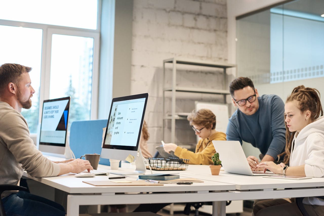 Team collaborating in a modern office using digital tools to automate and manage member communications.