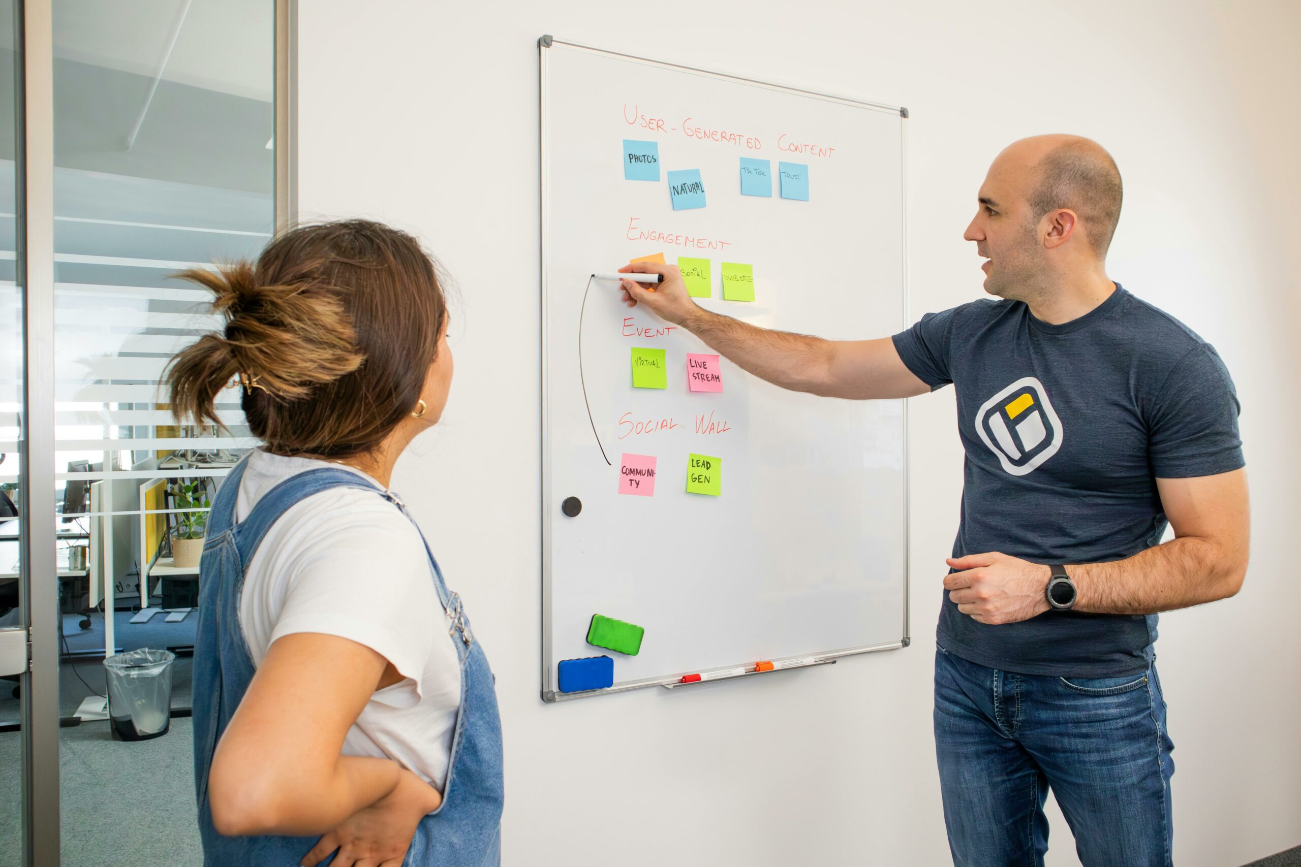 Marketing team brainstorming branded content ideas on a whiteboard to boost association engagement.