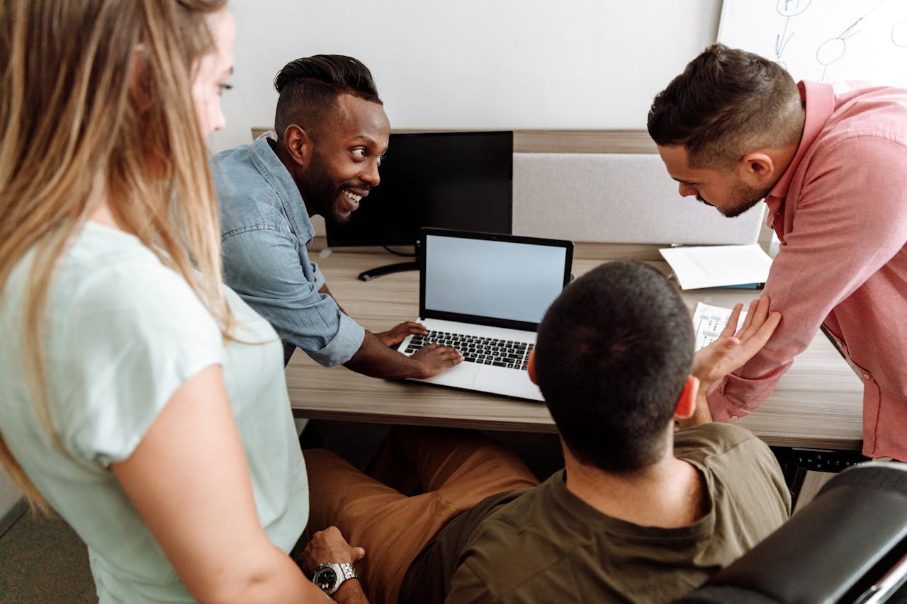 Team reviewing marketing performance on a laptop during a strategy meeting.