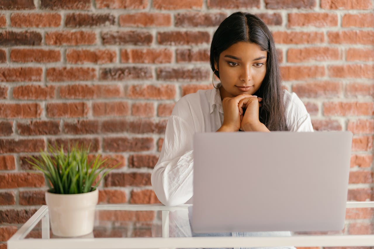 Professional woman engaging with her association’s online tools on a laptop, representing digital member engagement.