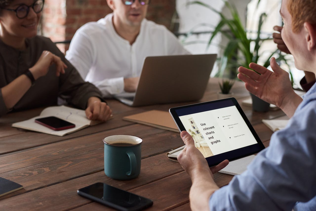 Team reviewing member engagement insights together on a tablet during a meeting