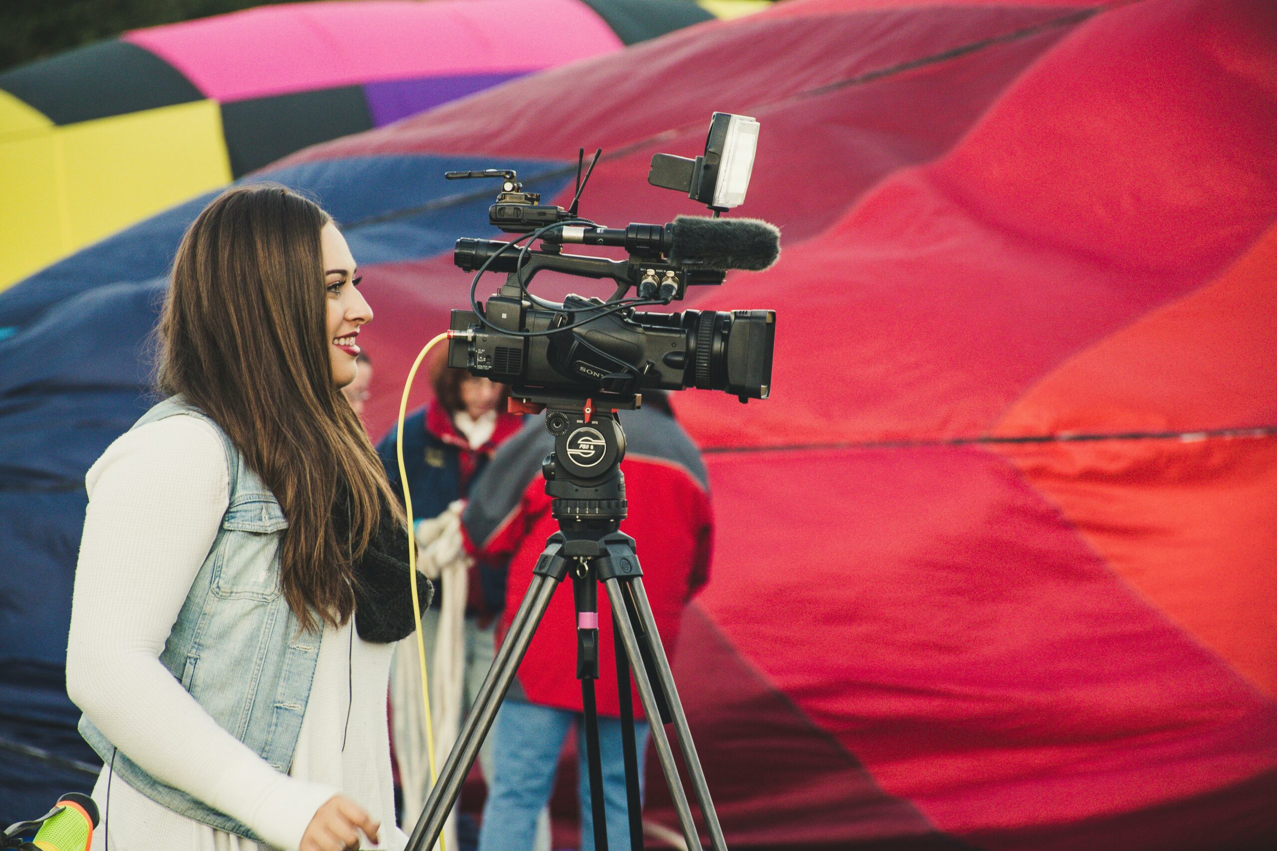 A woman is shooting an event coverage with livestream event production