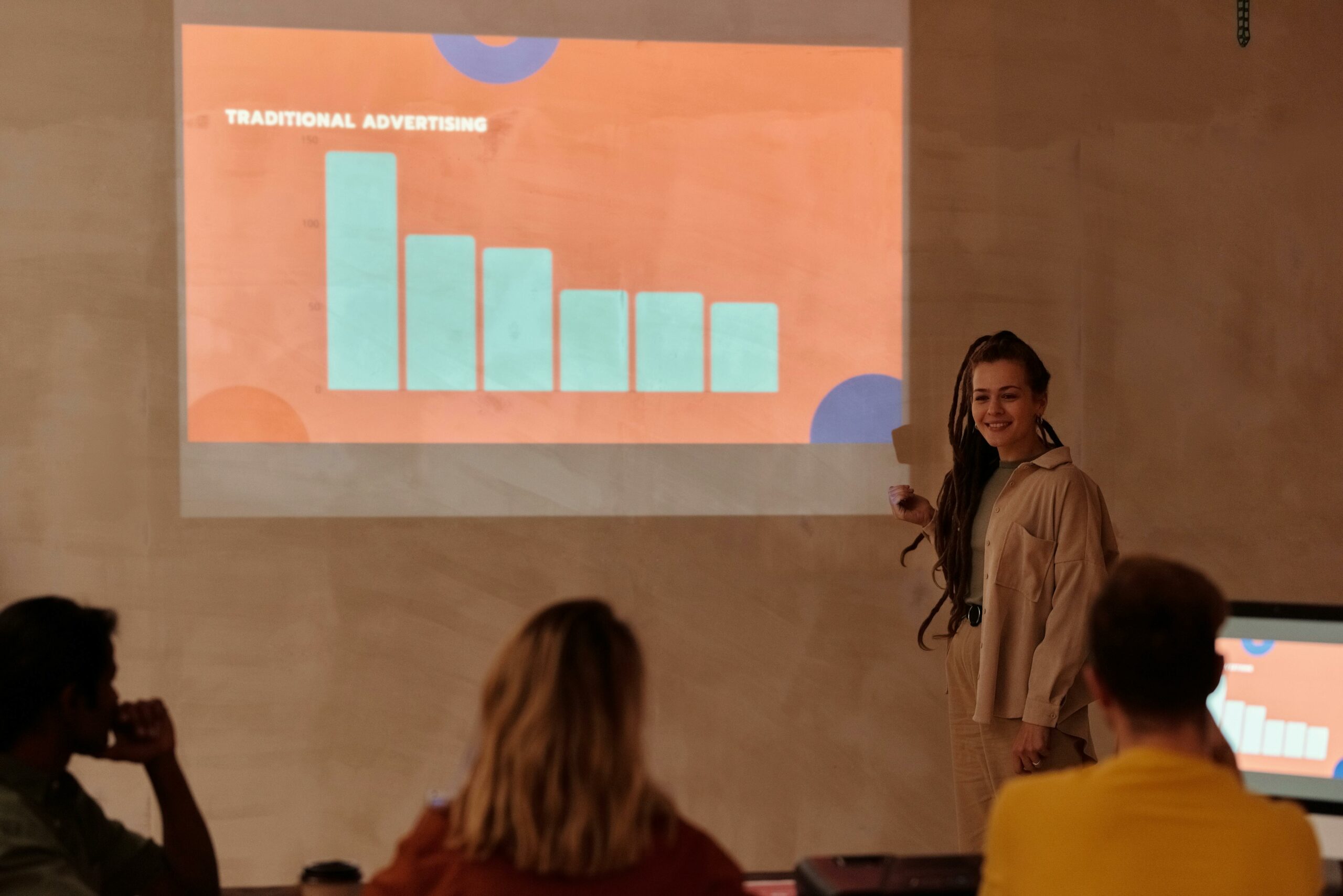 professional woman giving a presentation on paid advertising for associations