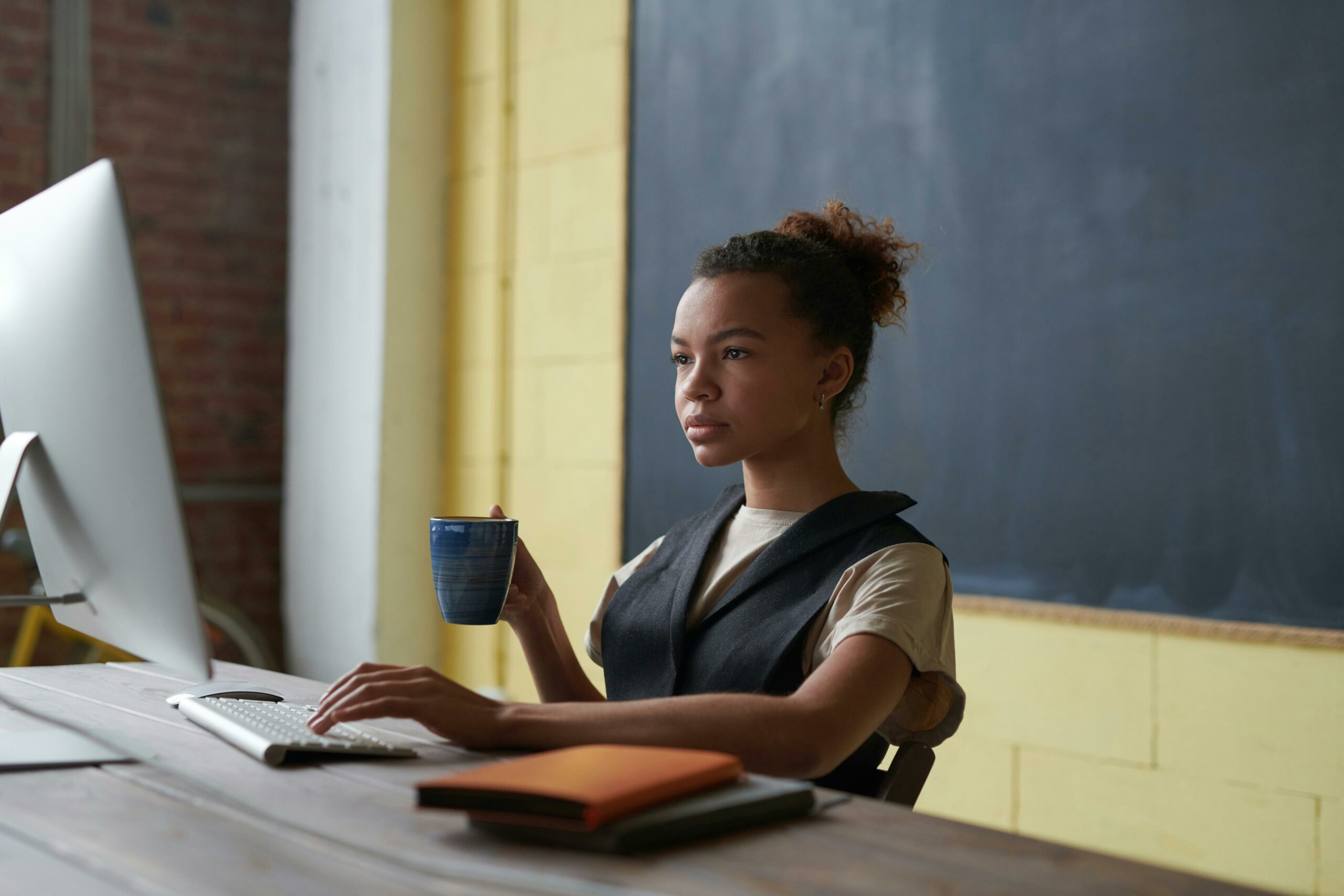 A woman is watching a webinar on her desktop in her home office. The webinar is an event sponsorship by an association's brand partner.