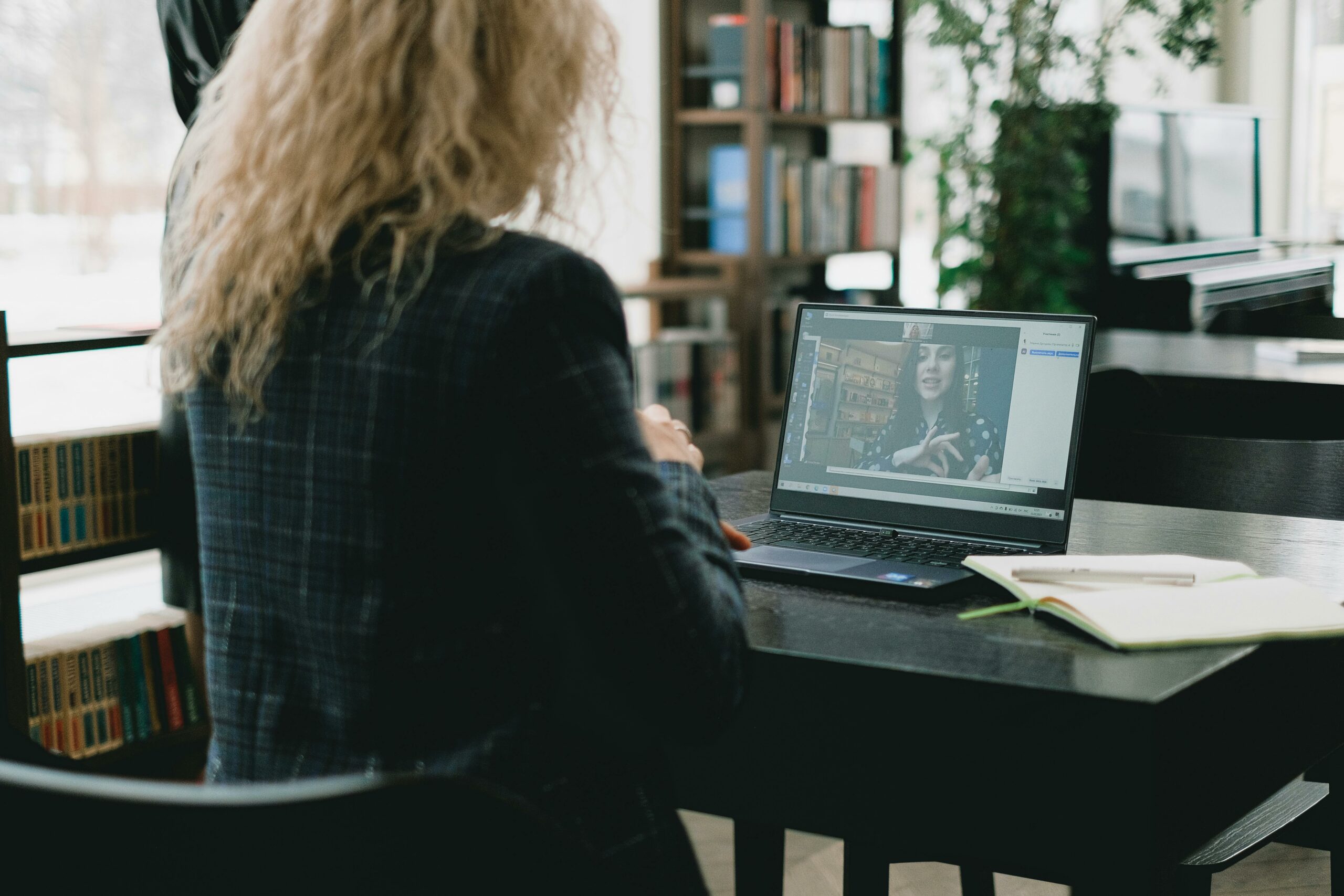 A woman is watching an on-demand training video for members of the association she is a part of.