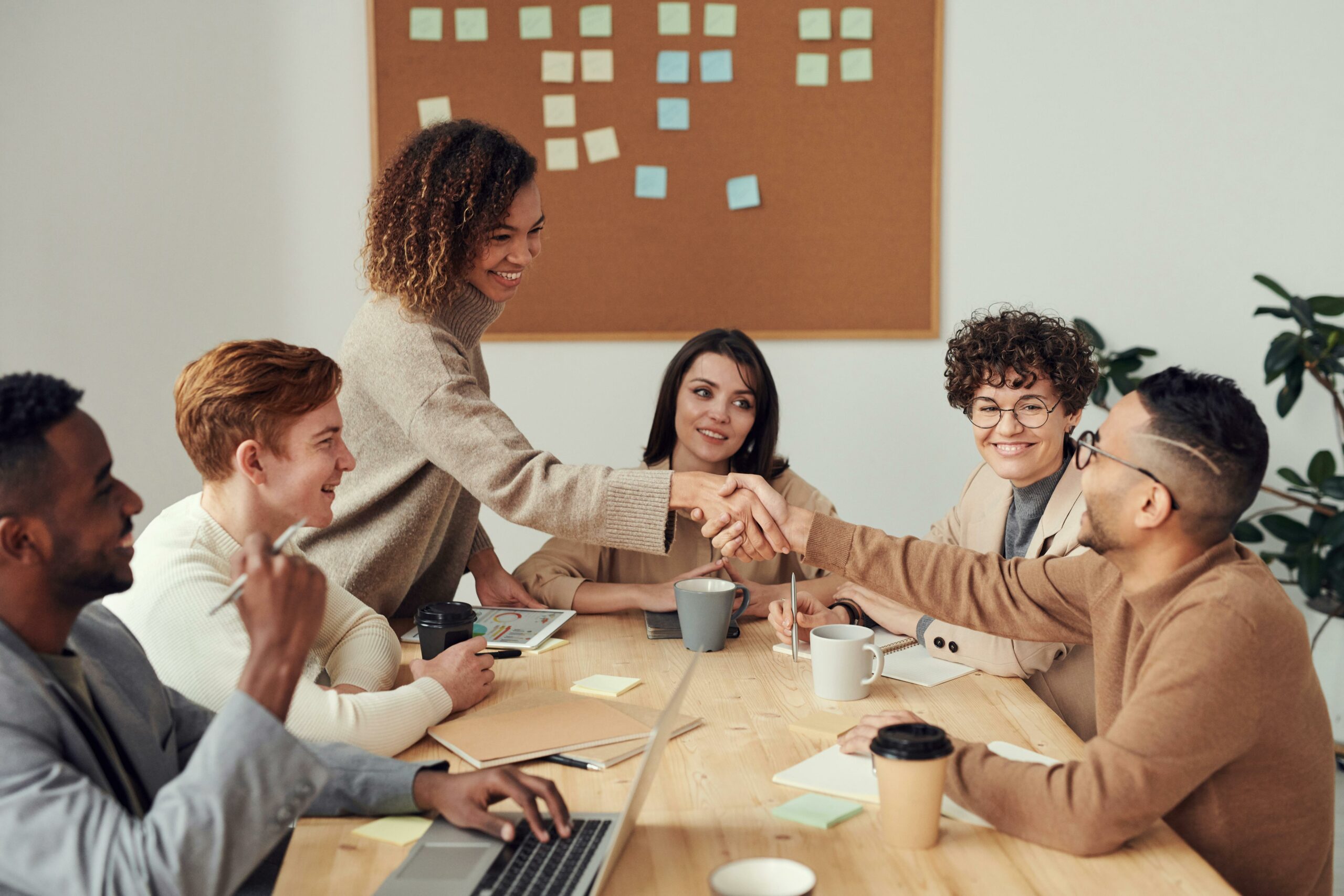 An association executive and brand partner are shaking hands to formalize the partnership for branded content, media campaign and digital sponsorship.